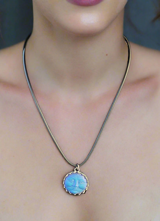 Blue moon-shaped pendant on a black cord