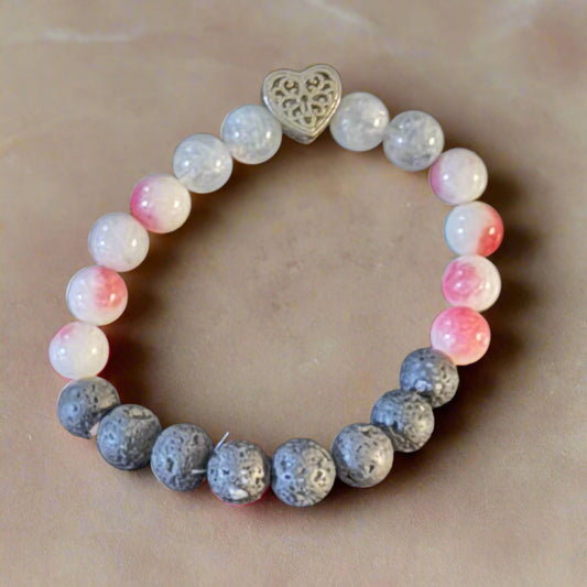 Heartfelt Balance Bracelet with Rhodonite, Milky Quartz, and lava beads, featuring a central heart-shaped charm, displayed on a soft background