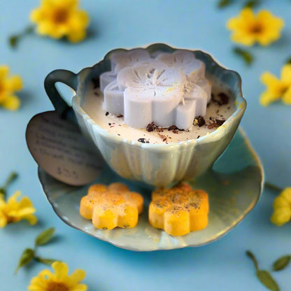 a soy wax candle hand-poured inside a Tiffany-blue teacup and saucer