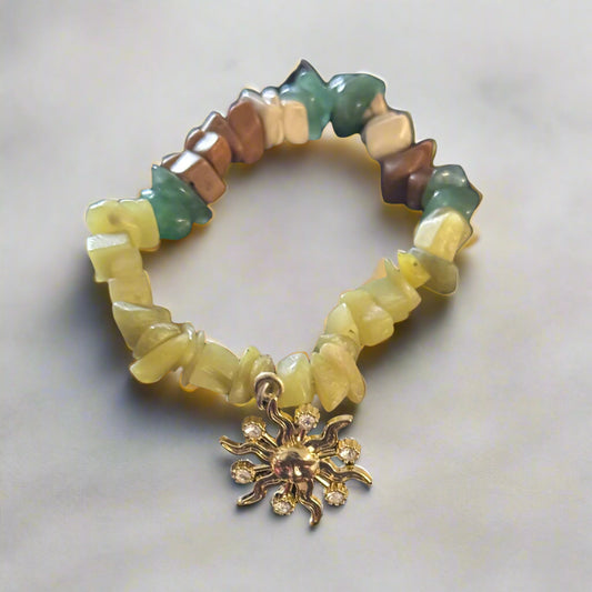 Golden Glow Sun Bracelet with radiant butter jade crystal chips, earthy tones, and a golden sun charm, displayed on a soft background