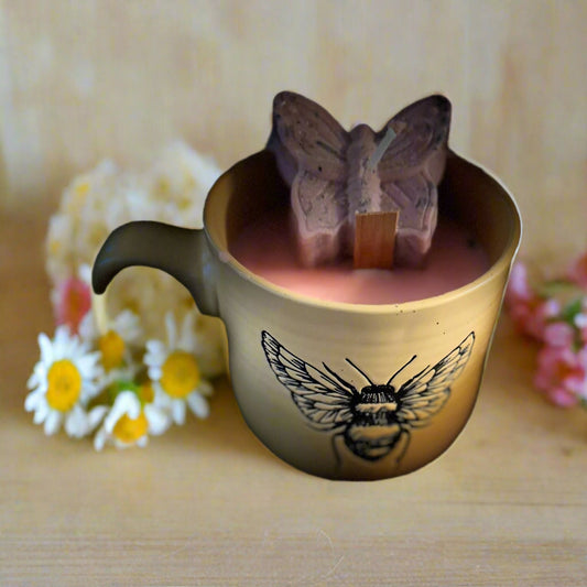 yellow bee ceramic mug with soy wax, wood wick candle inside, pink butterfly wax melt topper